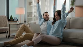 Excited happy young family win with laptop at home floor achievement online victory couple man woman husband wife winning with computer internet achieve kissing celebrating applauding betting success - Powered by Shutterstock - Get 15% off with code: PIKWIZARD15