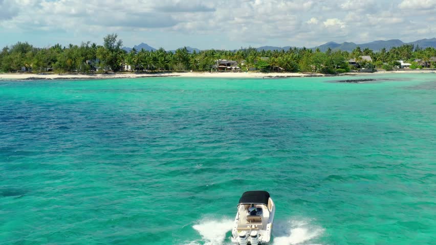 White powerboat heads towards the sandy beach in Mauritius island. Royalty-Free Stock Footage #1106600781