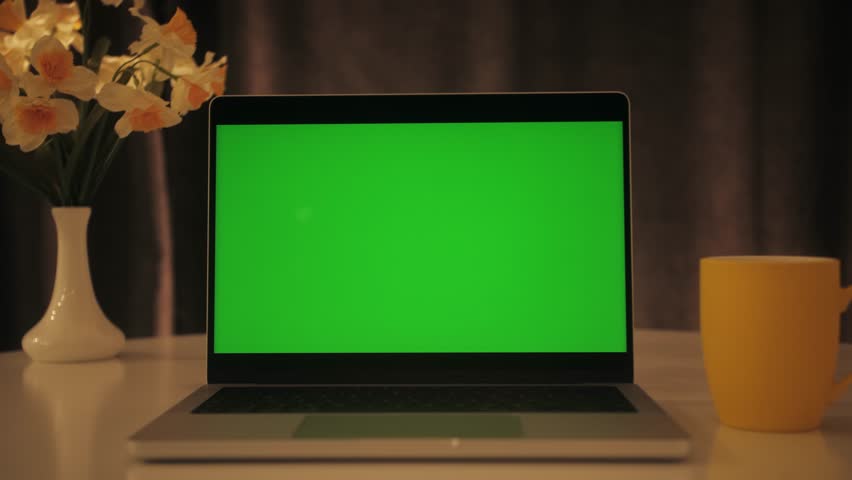 Close up of modern chroma key green screen laptop set up for work on desk at night, concept of remote work, technology concept. Royalty-Free Stock Footage #1106601393