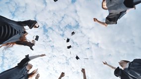 Joyful graduates stand in a circle and toss their caps up. - Powered by Shutterstock - Get 15% off with code: PIKWIZARD15
