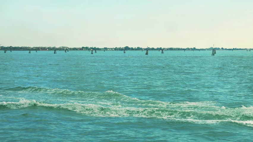 The bricole is distinctive landscapes details of the Venetian Lagoon that guide boats through it calm waters. Venice, Italy.