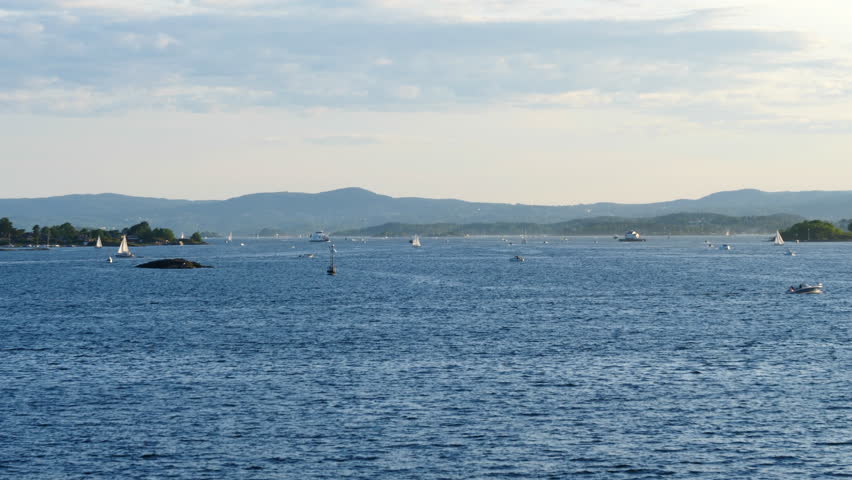 Peaceful scene with sailboats sailing off the coast of Oslo on summer day. Static