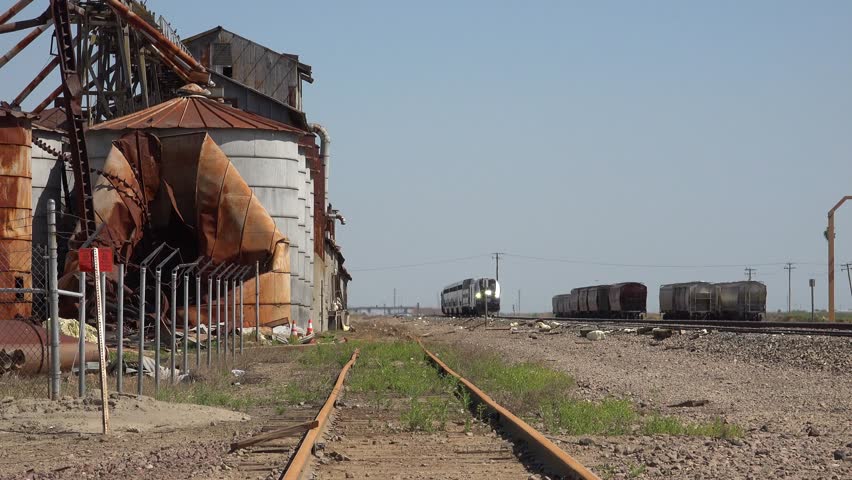 San joaquin valley, california - circa 2023 - an amtrak train passes through arid land in california