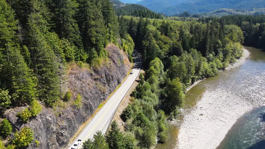 Mountain Loop Highway in Verlot, Washington. Follow the trail alongside the picturesque Stillaguamish River. Aerial drone flight captures the serenity and natural wonders of the landscape.