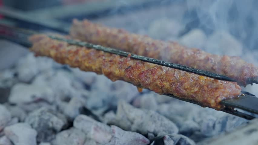 Traditional Turkish Adana Kebab. Turkish kebab barbecue grill with smoke. Royalty-Free Stock Footage #1106624459