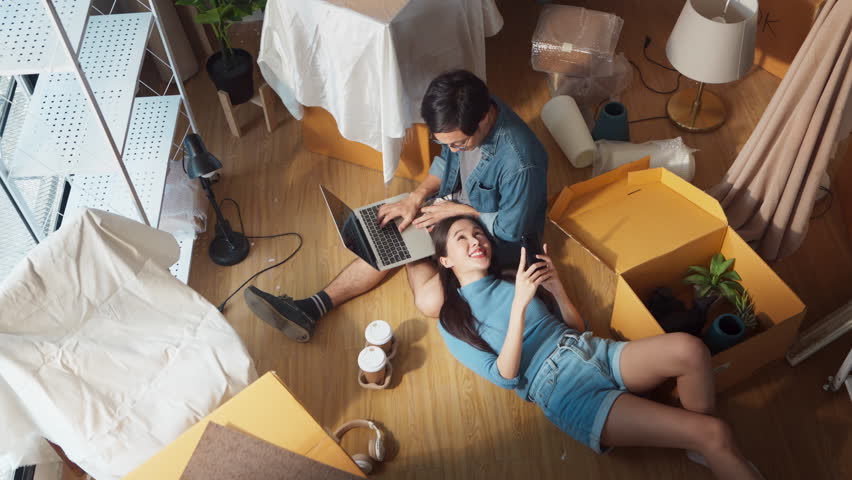 Happiness asian lover couple lying on your lap postive conversation taking a break between home relocation home moving in to new house happiness casual house renovation, asian couple lying on floor  | Shutterstock HD Video #1106625171
