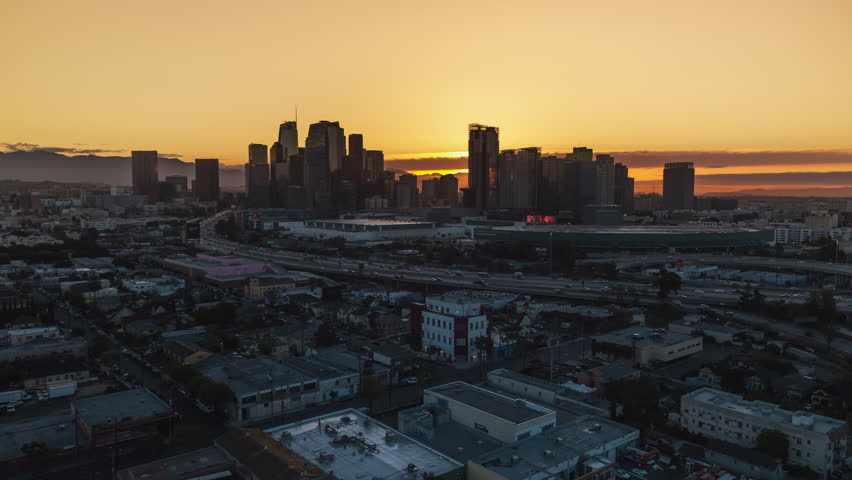 Establishing Aerial View Shot of Los Angeles LA CA, L.A. California US, Sunrise, Downtown LA, DTLA, LA Skyline, circling left, busy freeway in the morning Royalty-Free Stock Footage #1106625561