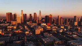 Establishing Aerial View Shot of Los Angeles LA CA, L.A. California US, Downtown LA, DTLA, LA Skyline, magical red light, stunning, circling right