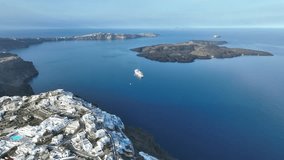 Cinematic 4k aerial video of Fira on the edge of the caldera cliff on Santorini, Greece