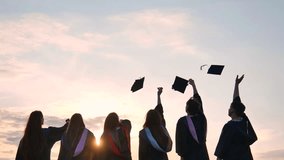 Silhouettes of graduates toss their caps at sunset. - Powered by Shutterstock - Get 15% off with code: PIKWIZARD15