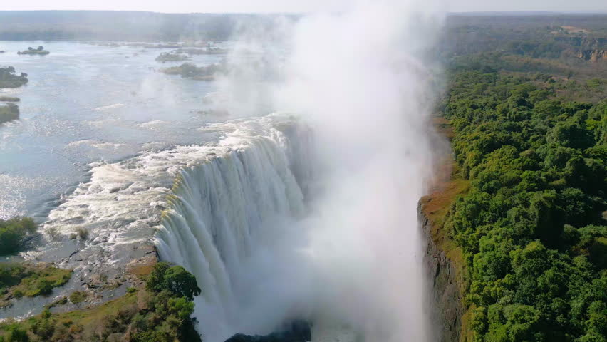 Arial view of the mighty Victoria Falls between Zambia and Zimbabwe Royalty-Free Stock Footage #1106628613