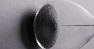 Vertical video of hourglass with sand pouring, copy space on grey background. Time and time keeping concept.