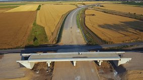 Aerial Drone footage of a brand new highway under construction filmed at dusk. Almost completed freeway construction project. Road building for the future.