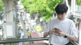 4K Asian man typing online text message chatting on mobile phone app or making payment online shopping in the city. Digital nomad people freelancer working anywhere on smartphone with online network. - Powered by Shutterstock - Get 15% off with code: PIKWIZARD15