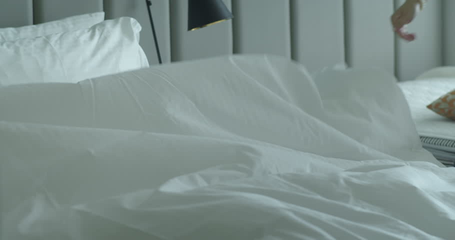 Employees, two maids of the hotel, professionally make the bed in the client's room. Five-star hotel concept and quality room service. Womans changing the bedding in the room. 4k Royalty-Free Stock Footage #1106637641
