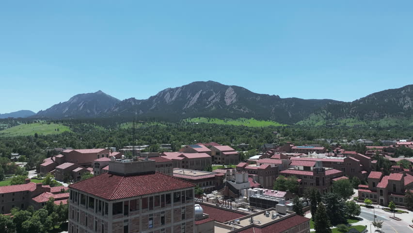 University of Colorado Campus Buildings and Flatiron Mountains on Sunny Day, Boulder USA, Drone Aerial View