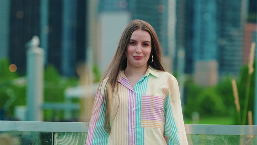 I Don't Want to hear this conept reaction. Beautiful girl covers ears with palms in middle of downtown Chicago Illinois USA