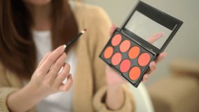 Close-up attractive young influencer woman share makeup tutorials on social media. Beauty blogger sells cosmetics shopping online. Makeup artist vlogger teaching on social media. - Powered by Shutterstock - Get 15% off with code: PIKWIZARD15