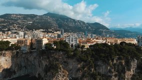 Beautiful cinematic aerial video of Saint Nicholas Cathedral and Monte Carlo cityscape. Flying over above Monaco Hercules harbour, port for Grand Prix de Monaco view from the sea on a sunny summer day