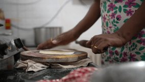 Asian House wife making chapati, roti, Making round roti from wheat flour, cooking in kitchen , 10 Bit 422 Colors - Powered by Shutterstock - Get 15% off with code: PIKWIZARD15
