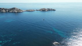 Immerse in Marseille's Calanques with 4K drone footage. Explore the Mediterranean coastline, tranquil sea, remote islands, sailboats, and birds. Perfect for projects needing a touch of natural beauty.