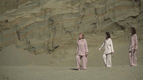 three women are dancing. three women in the desert. dancing for women. slow motion video. High quality Full HD video recording
