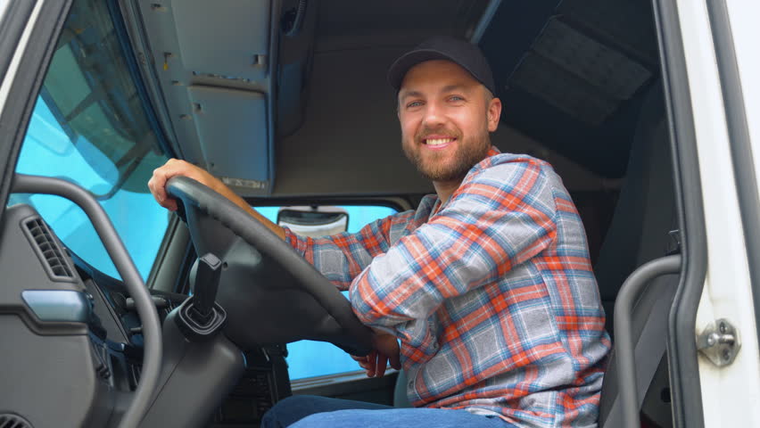 Truck driver sitting in his truck. Trucker occupation. Transportation services Royalty-Free Stock Footage #1106654907