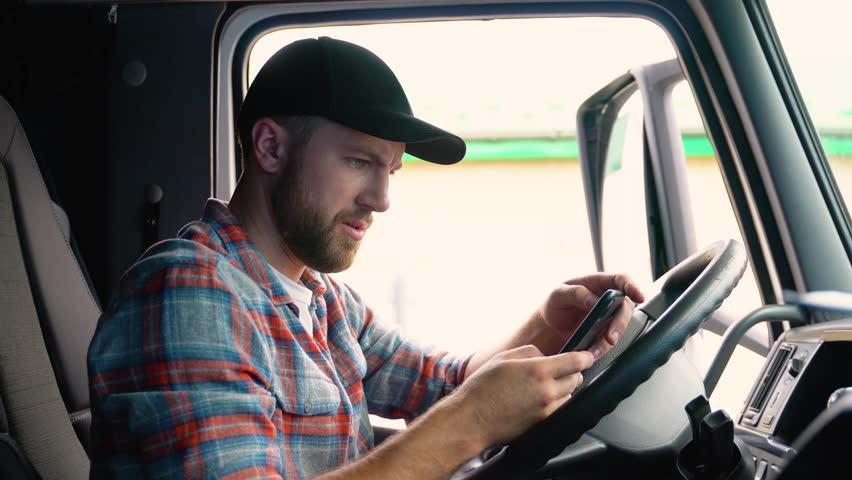 Professional trucker using truck gps navigation to transport and deliver goods to the destination. Transportation services. Royalty-Free Stock Footage #1106654921