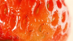 Macro video showcases the mesmerizing details of a strawberry - vibrant red hue, tiny seeds, and intricate texture, capturing its beauty up close in a captivating. 4K HDR. Strawberry background

