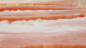 Capturing the intricate details of raw bacon. Watch as its velvety texture and rich colors ignite the senses, setting the stage for a culinary delight. Processed food concept. Bacon background

