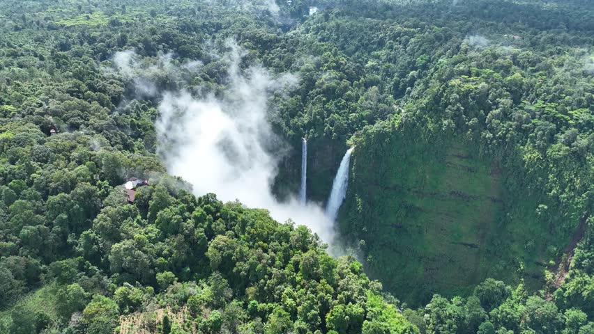 The Tad Fane waterfall, on the Bolaven Plateau in Laos, a few kilometers west of Paksong Town, in Champasak Province, within the Dong Houa Sao National Protected Area.bird eye view,aerial view Royalty-Free Stock Footage #1106656493