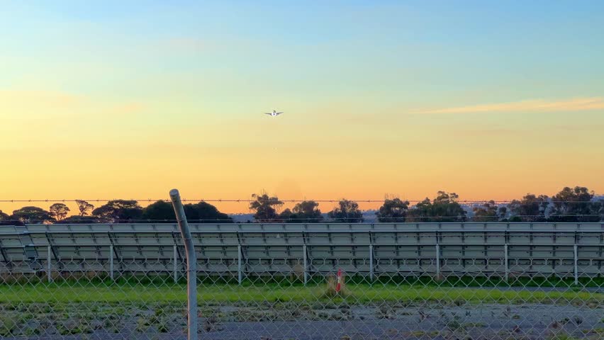 Plane landing at Melbourne Airport in Victoria Australia at sunset
