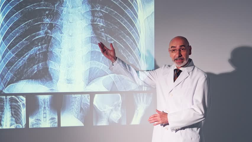 Middle aged Caucasian doctor presenting medical research using a projector screen.