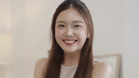 Beauty Asian woman with natural look make up lookin and smiling to camera. - Powered by Shutterstock - Get 15% off with code: PIKWIZARD15