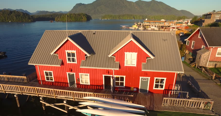 Flying Away From Coastal Dock House With Kayaks on the Side on Vancouver Island