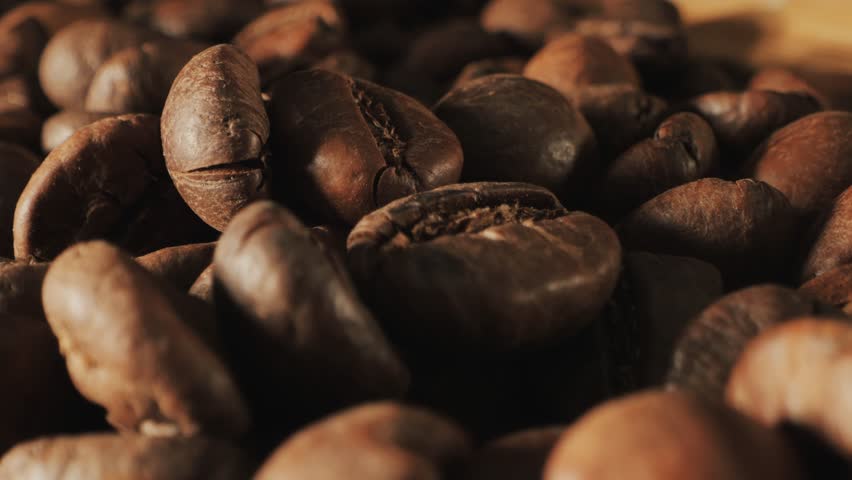 Сoffee background. Coffee beans slow motion. Coffee beans close-up. Roasted coffee beans spinning. Close up of seeds of coffee. Royalty-Free Stock Footage #1106672547