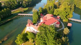 Picturesque 4K drone footage of Castle Otočec in beautiful sunny light. Video shows this historic gem embraced by the Krka River. Captivating Slovenia's beauty from aerial perspective.