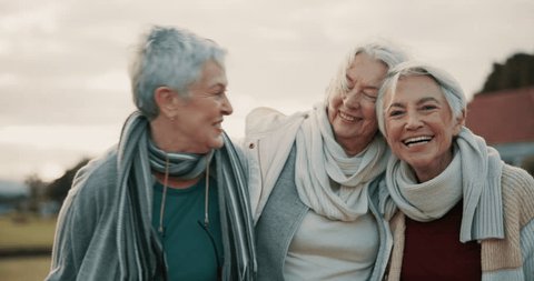 Comedy, laughing and senior woman friends outdoor in a park together for bonding during retirement. Portrait, smile and funny with a happy group of elderly people bonding in a garden for humor or fun Adlı Stok Video