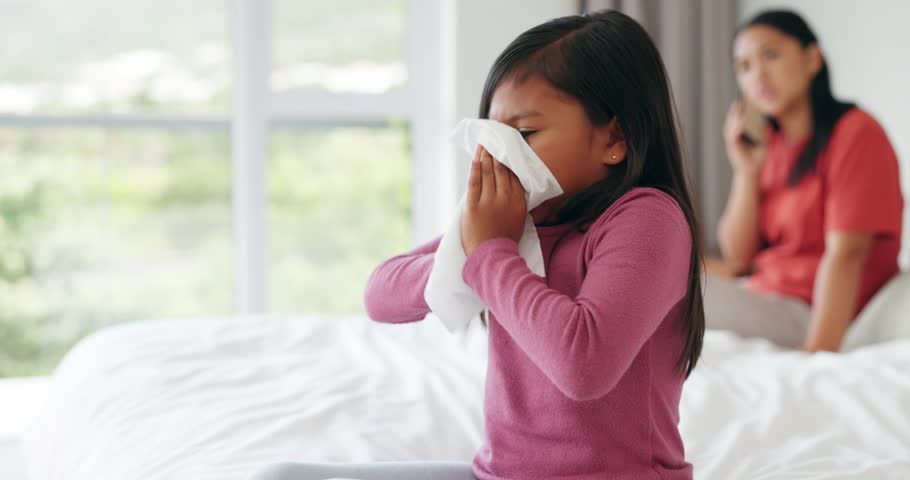 Paper, sick and child sneeze in bedroom home with allergy, virus or covid. Tissue, kid and girl blowing nose in bed for allergies, health problem and bacteria, cold or fever with mother on phone call Royalty-Free Stock Footage #1106684939