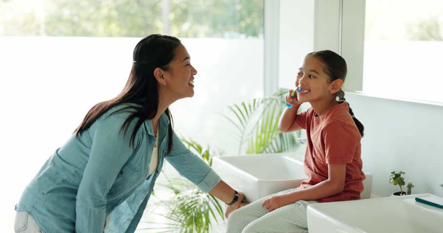 Mother, teaching or kid in bathroom brushing teeth together for learning or child development at family home. Morning, happy mom or girl cleaning mouth with toothbrush or toothpaste for dental health