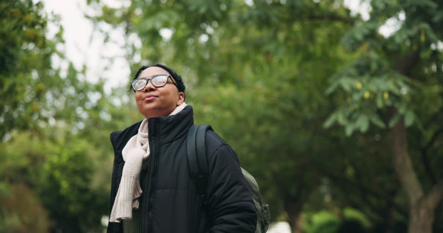 Freedom, smile and woman hiking in a forest, peaceful and enjoying outdoor experience. Nature, walk and female hiker in the woods happy with fresh air, scenery and solo trip journey to camp site