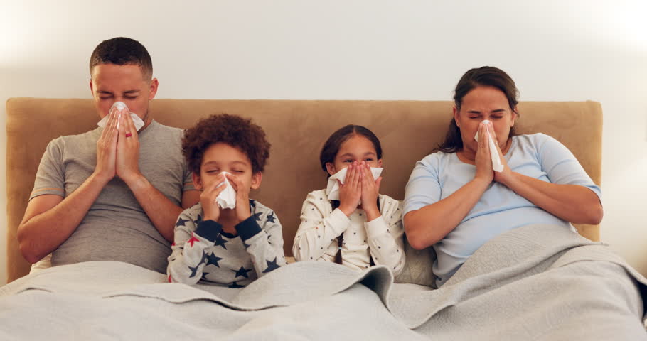 Sick, bed and family blowing their nose while relaxing together with a cold, flu or allergies. Illness, rest and parents in hayfever recovery with their children in the bedroom of their modern house. Royalty-Free Stock Footage #1106686383