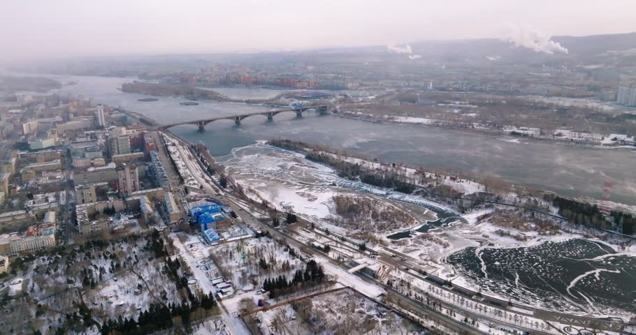 General view of Krasnoyarsk taken from a drone. Yenisei River Russia Siberia, Krasnoyarsk region Krasnoyarsk, wintertime Royalty-Free Stock Footage #1106687213