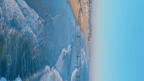 Aerial View Of The Famous Venice Pier in Los Angeles California. Aerial Of Venice Beach Fishing Pier, Marina del Rey, Los Angeles, California During Summer - drone shot. Aerial vertical video. 