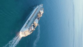 Cruise ship sailing across The Mediterranean sea - Aerial footage. Aerial top view of luxury large cruise ship. Aerial vertical, vertical video background. 