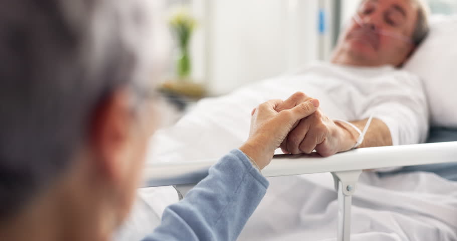 Hospital, bedroom and senior couple holding hands, empathy and support husband recovery, healthcare problem or rehabilitation. Retirement, comfort or elderly woman care for sick cancer patient in bed Royalty-Free Stock Footage #1106693907