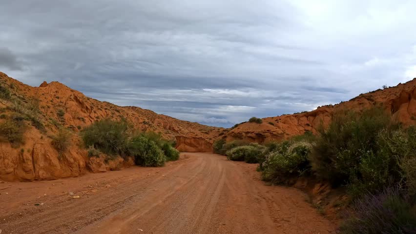 A trip along a country road along a beautiful natural canyon. The unusual landscape of the Red Canyon of extraordinary beauty is similar to the Martian landscape. Amazingly beautiful landscape.