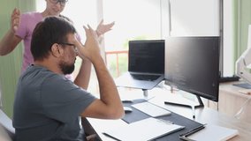 The head of the team yells at the programmer because he made a mistake. The programmer grabs his head. Active gesticulated. Mistake in production. Code. Dual-monitor workstation - Powered by Shutterstock - Get 15% off with code: PIKWIZARD15