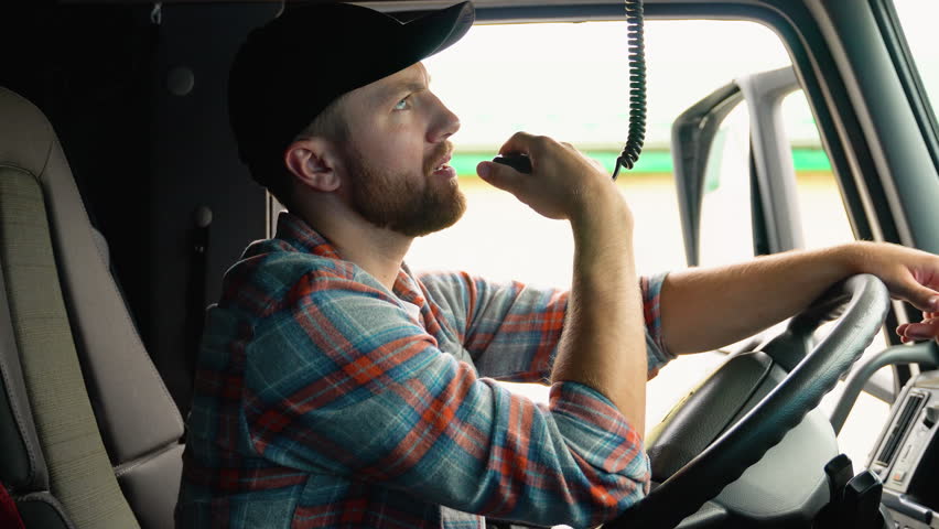 Trucker Preparing For Trip. Caucasian Men Talking on CB Radio. Truck Driver Job Royalty-Free Stock Footage #1106701949