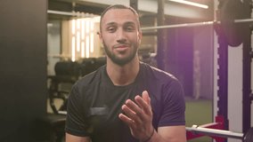 Friendly fitness trainer African American ethnic sport man guy athletic sportsman athlete blogger vlogger talking at camera in gym talk speak video call vlog tutorial workout exercise sports channel - Powered by Shutterstock - Get 15% off with code: PIKWIZARD15